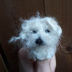 felt-making-workshops-puppet-mini Dog finger puppet, made from white felt.